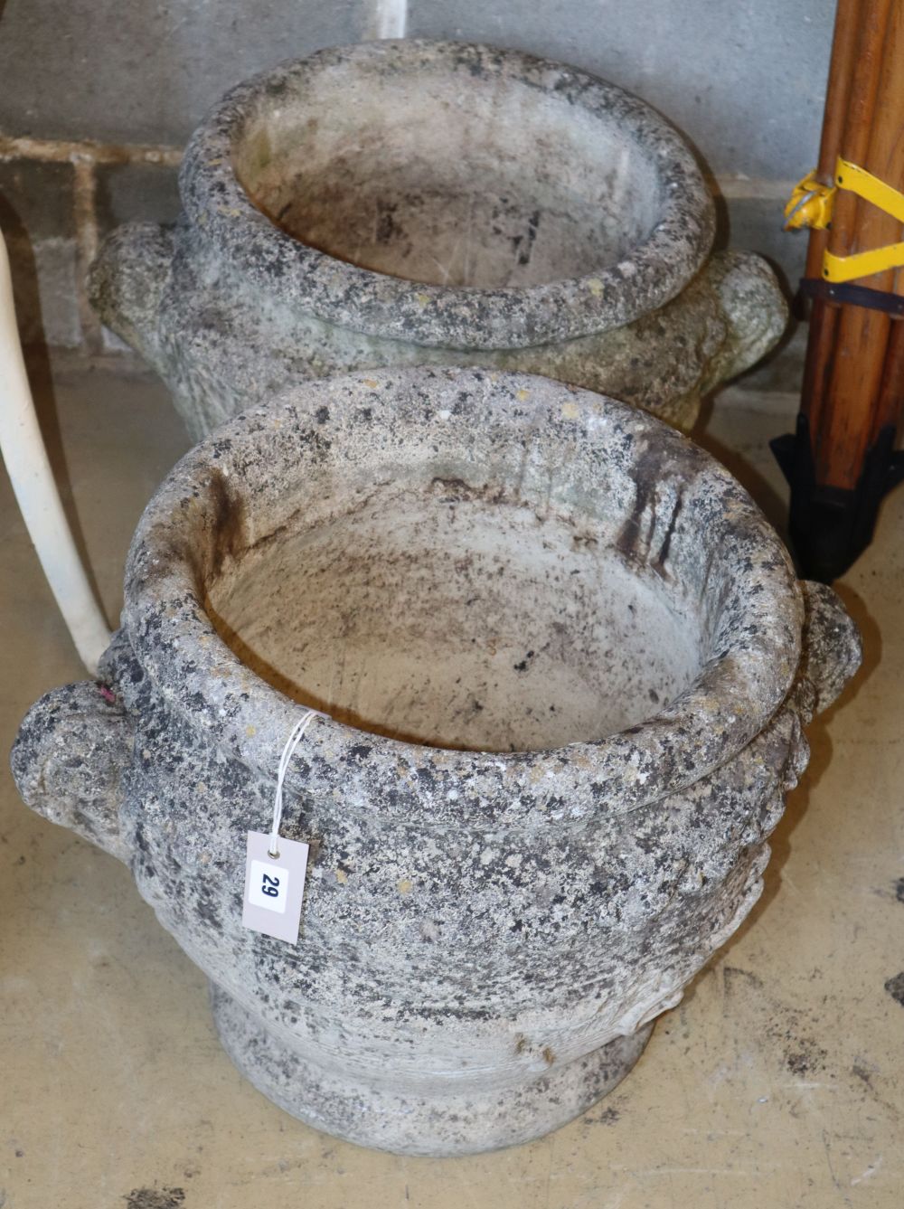 A pair of circular reconstituted stone garden planters, 40cm diameter, H.40cm